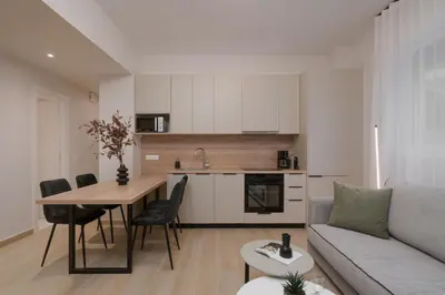 a kitchen and living room with a table and a couch at Athenian Modern & Luxury Apartments in Athens