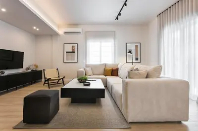 a living room with a white couch and a table at Athenian Modern & Luxury Apartments in Athens