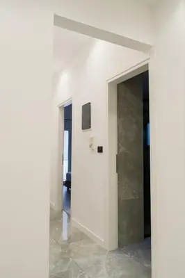 a hallway with a white wall and a doorway at 2 br cozy stylish apartment in Athens