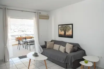 a living room with a couch and a table at Anthilia's House in Porto Rafti