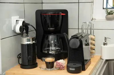 a black coffee maker on a counter in a kitchen at Anthilia's House in Porto Rafti