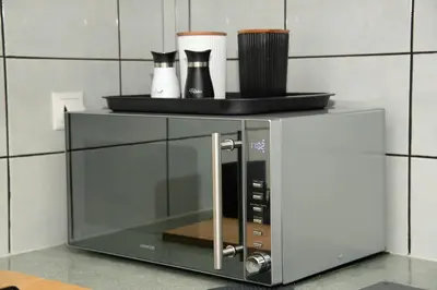 a microwave oven with two cups on top of it at Anthilia's House in Porto Rafti