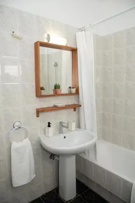 a bathroom with a white sink and a mirror at Anthilia's House in Porto Rafti
