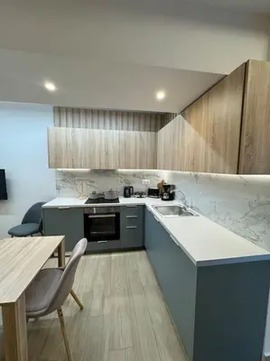 a kitchen with a counter and a table and a counter top at Quiet Studio With Free Parking in Athens