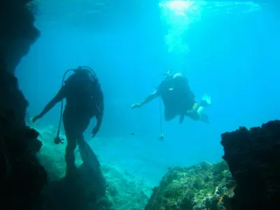 two people are scuba diving in the ocean at Villa Achilleas by the sea in Anavissos