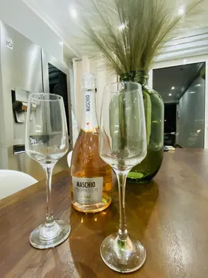 two wine glasses and a bottle on a table at Marina Zeas Seaview House-MarinaQ in Piraeus