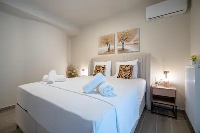 a white bedroom with a large white bed at Ilisia 2 person apartment by MPS in Athens