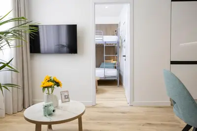 a living room with a table and a room with a bed at Hestia - Asklipiou 9 in Athens