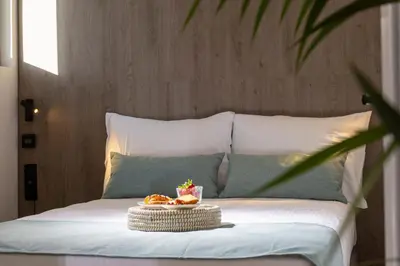 a bed with a tray of food on it at Hestia - Asklipiou 9 in Athens