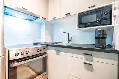 a kitchen with a stove and a microwave at Kipseli 2 prsn studio by MPS in Athens