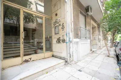 a building with graffiti on the side of it at Kipseli 2 prsn studio by MPS in Athens
