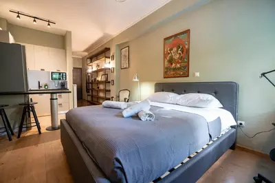 a bedroom with a bed with a cat laying on it at Kipseli 2 prsn studio by MPS in Athens