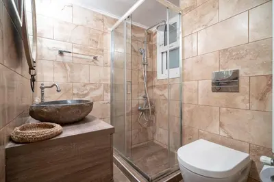 a bathroom with a shower and a sink and a toilet at Kipseli 2 prsn studio by MPS in Athens
