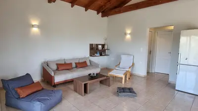 a living room with a couch and a table at Keratea Hillside House in Keratea