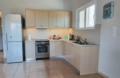 a kitchen with white appliances and a white refrigerator at Keratea Hillside House in Keratea
