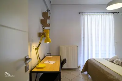 a bedroom with a desk with a bed and a lamp at Thyme Out - Modern Apartment in Egaleo-Athens in Athens