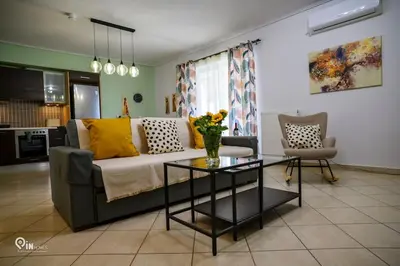 a living room with a couch and a table at Thyme Out - Modern Apartment in Egaleo-Athens in Athens