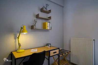 a room with a desk with a lamp and a radiator at Thyme Out - Modern Apartment in Egaleo-Athens in Athens