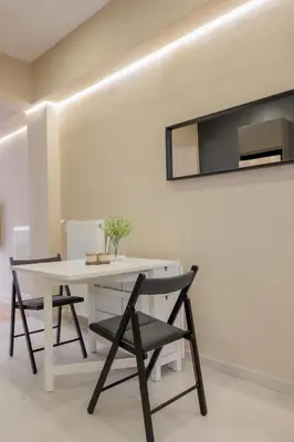 a white table and chairs in a room with a mirror at Modern 2BDR Apt - 2' to Metro - Direct to Acropolis in Athens