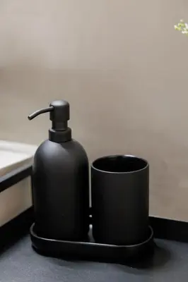 a black soap dispenser sitting next to a cup at Modern 2BDR Apt - 2' to Metro - Direct to Acropolis in Athens