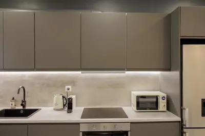 a kitchen with white cabinets and a sink and a microwave at Modern 2BDR Apt - 2' to Metro - Direct to Acropolis in Athens