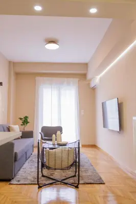 a living room with a couch and a table at Modern 2BDR Apt - 2' to Metro - Direct to Acropolis in Athens