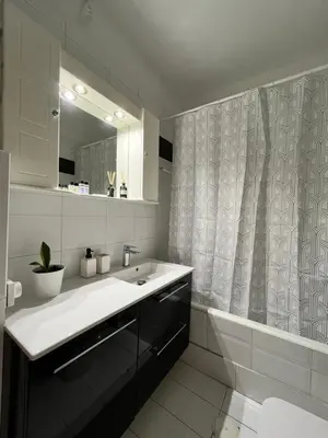 a bathroom with a sink and a shower curtain at Quiet Apartment with Garden View in Kolonaki in Athens