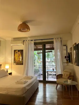 a bedroom with a bed and a sliding glass door at Quiet Apartment with Garden View in Kolonaki in Athens