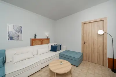 a white living room with a white couch and a table at Φ Villa by A&D Properties in Porto Rafti