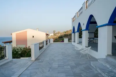 a balcony of a house with a view of the ocean at Φ Villa by A&D Properties in Porto Rafti