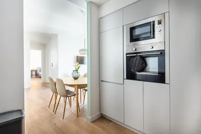 a white kitchen with a table and a microwave at Nostalgia 1-Bedroom Apartment in Athens in Athens