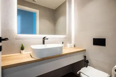 a bathroom with a sink and a mirror and a toilet at Nostalgia 1-Bedroom Apartment in Athens in Athens