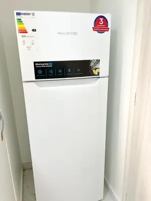 a white refrigerator freezer sitting in a room at Cozy appartment Panathianiko Stadio in Athens