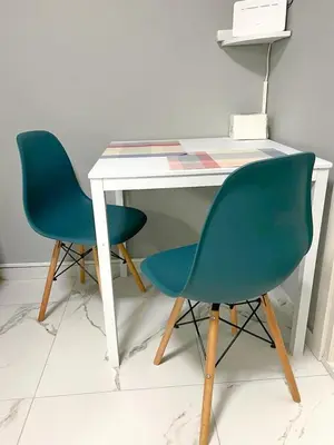 a desk with two chairs next to a white table at Cozy appartment Panathianiko Stadio in Athens