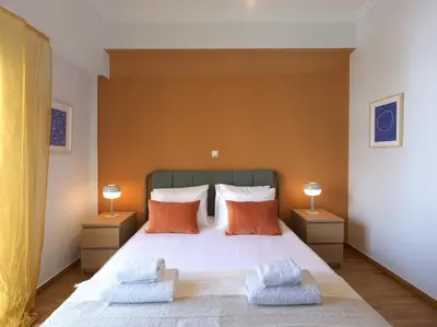 a bedroom with a large bed with two lamps at Marnis10 5th Right in Athens