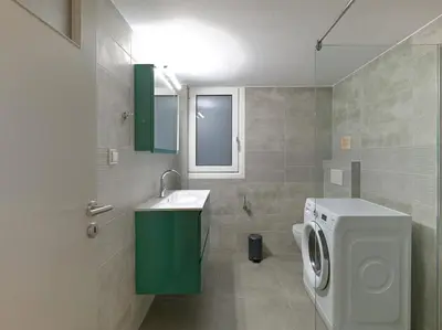 a bathroom with a washing machine and a sink at Marnis10 5th Right in Athens