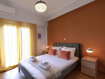 a bedroom with a bed with towels on it at Marnis10 5th Right in Athens