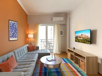 a living room with a couch and a table at Marnis10 5th Right in Athens