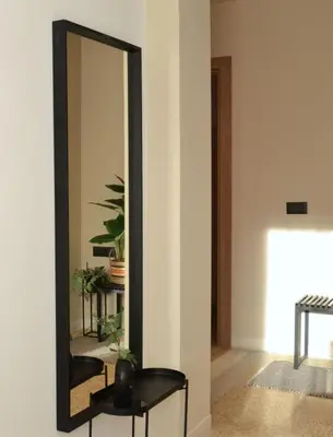 a mirror in a room with a chair and a table at Anasa Hotel Athens in Athens