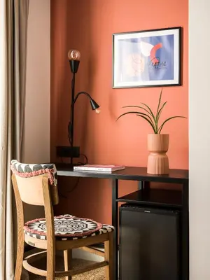 a room with a desk with a chair and a lamp at Anasa Hotel Athens in Athens