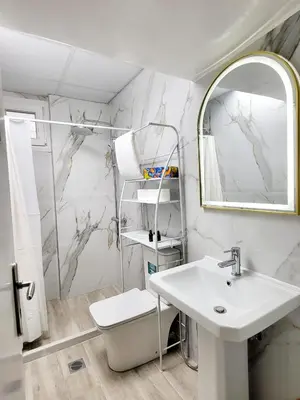 a white bathroom with a sink and a mirror at AHAMED GREEK SMPCO in Athens