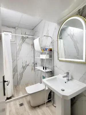 a white bathroom with a sink and a mirror at AHAMED GREEK SMPCO in Athens