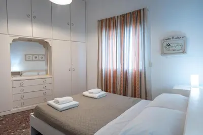 a bedroom with two beds and a mirror and a dresser at Keratsini 2 bedroom 4 pers apart by MPS in Piraeus