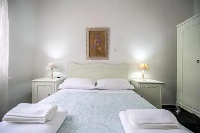 a bedroom with a bed with two white towels on it at Keratsini 2 bedroom 4 pers apart by MPS in Piraeus