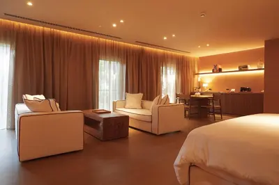 a hotel room with a bed and a living room at The Margi in Athens