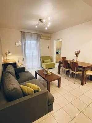 a living room with a couch and a dining room at CS Central Apartment in Athens