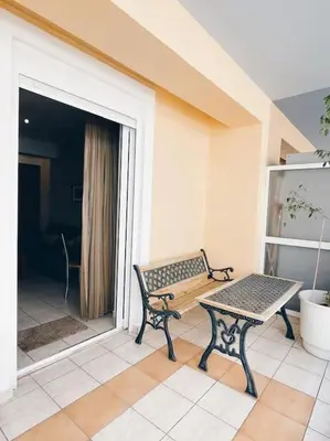 a bench sitting on a balcony with a table at CS Central Apartment in Athens