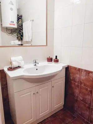 a bathroom with a white sink and a mirror at CS Central Apartment in Athens