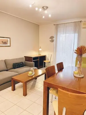 a living room with a table and a couch at CS Central Apartment in Athens