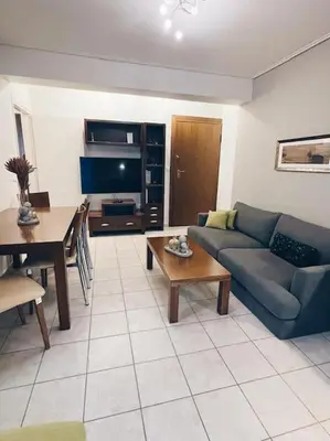 a living room with a couch and a table at CS Central Apartment in Athens